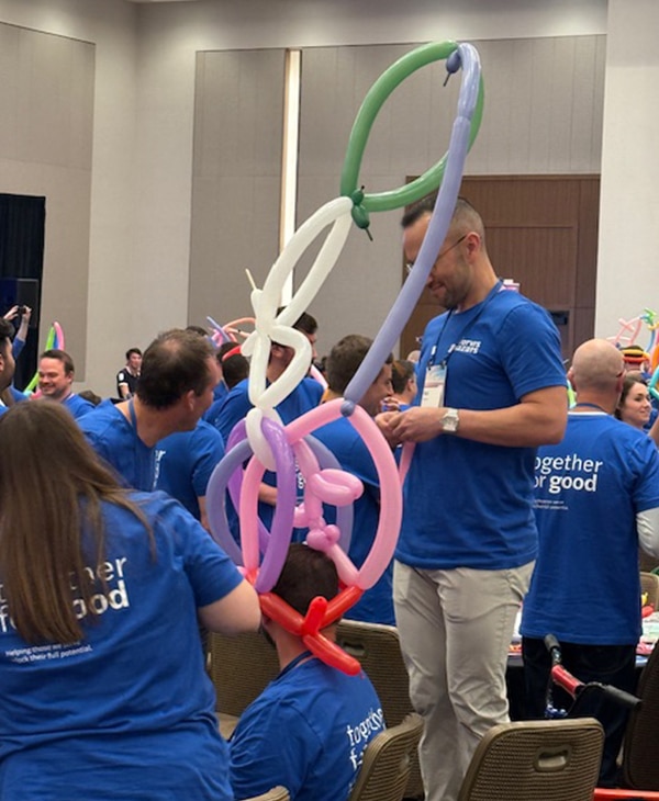 A very tall balloon hat made as an event during the team building program "wheels for the world"